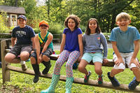 Berkshire campers sitting on fence rail