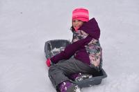 Girl sledding during February Vacation Week at Wachusett Meadow Wildlife Sanctuary
