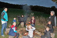 Sitting around the campfire at Wachusett Meadow's Halloween Night Hike & Hayride