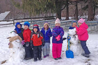 Preschoolers building snowmen at Wachusett Meadow