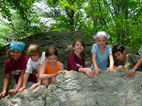 Climbing boulders during April Vacation at Wachusett Meadow