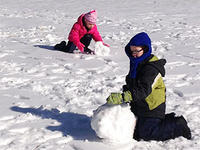 Kids making snowmen at Wachusett Meadow