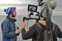 Thomas Underwood checks for turtles as BBC crew films him