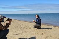 Educator Spring Beckhorn records a video on the beach