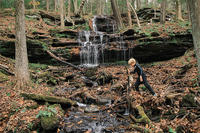 Older child hiking over a creek © Diana Chaplin