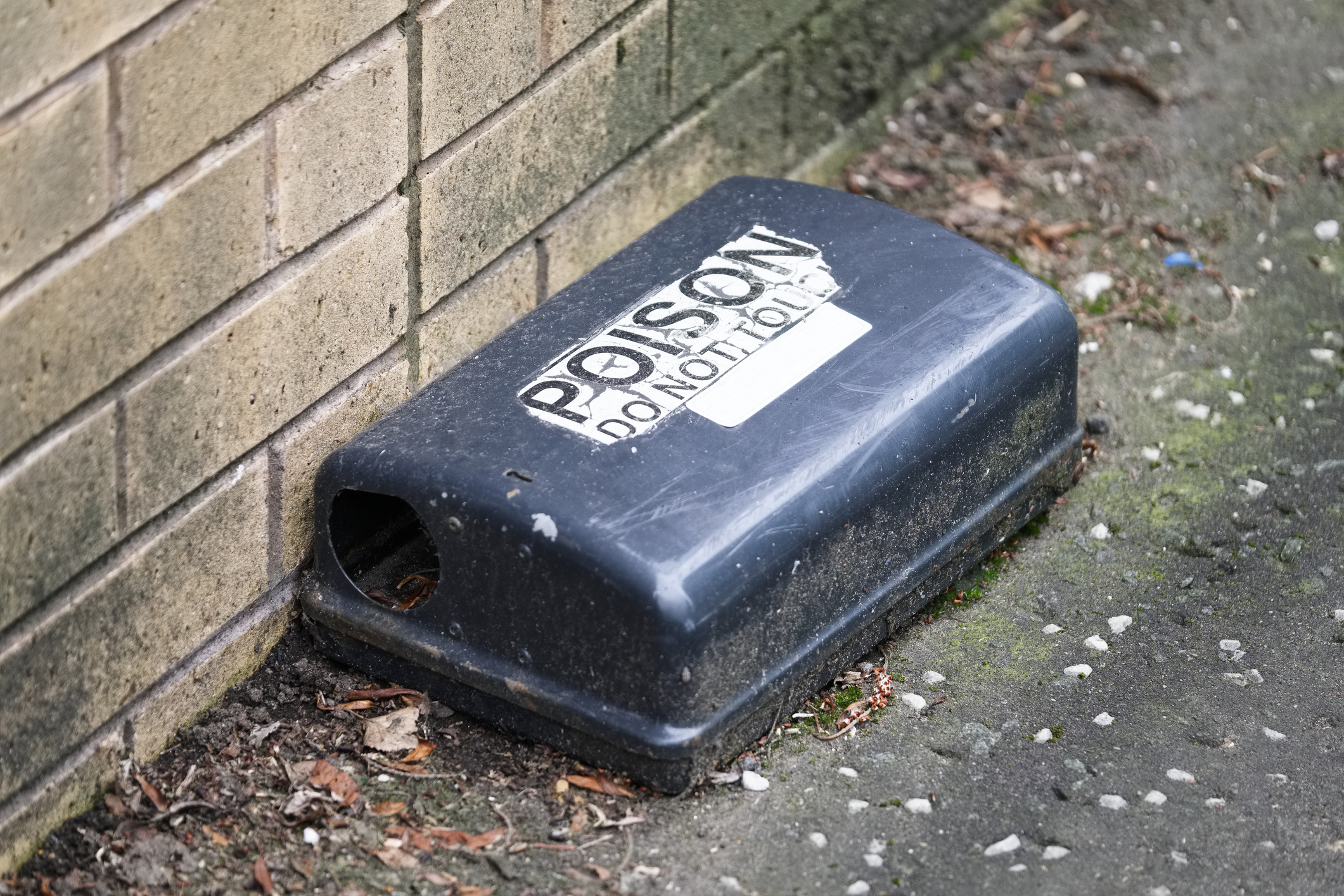 A black plastic box labeled "POISON, Do Not Touch"