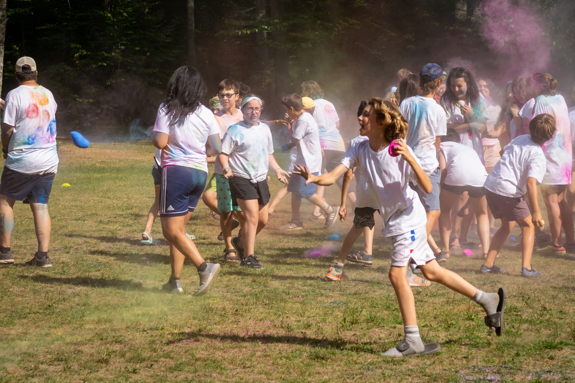 campers in white shirts throwing color on each other