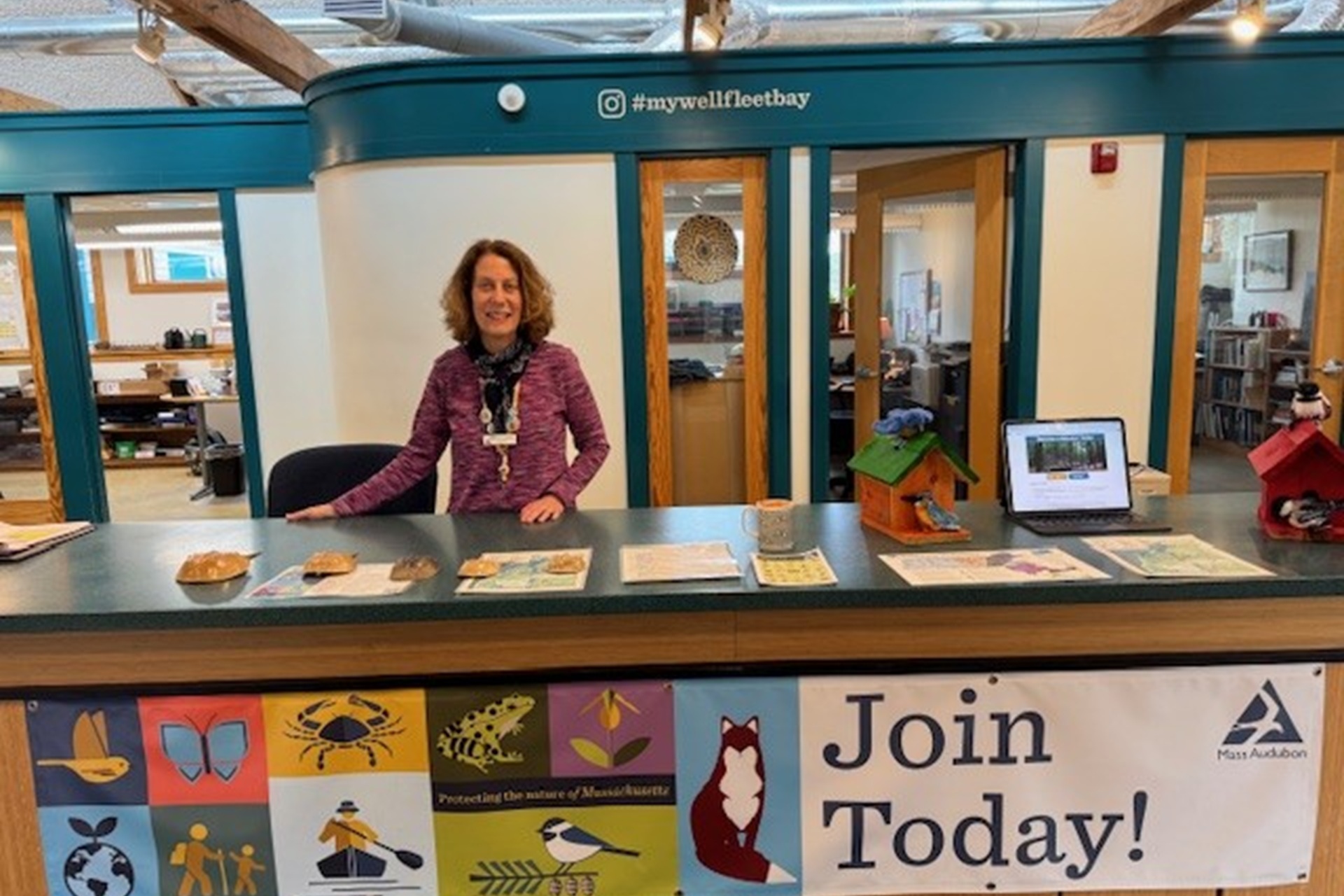 Wellfleet Bay volunteer Sharon Kreamer at the Nature Center front desk