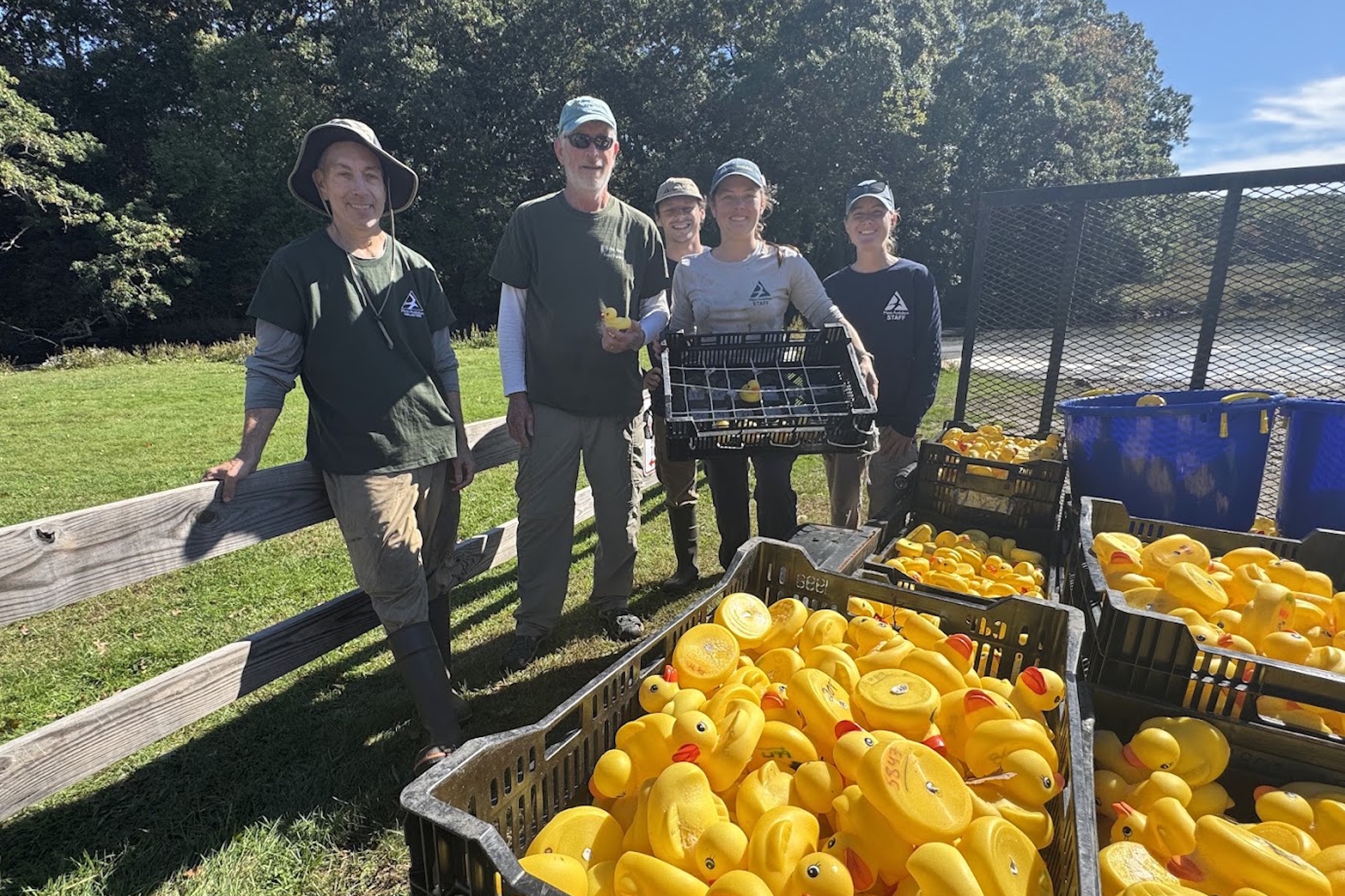 Allens Pond Staff with the winning Duck Derby rubber duck and its competitors