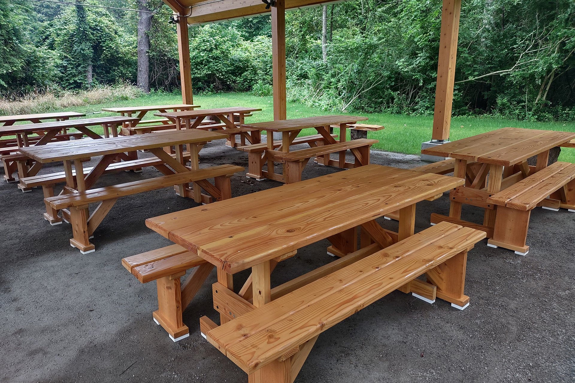 Newly installed picnic tables under an awning
