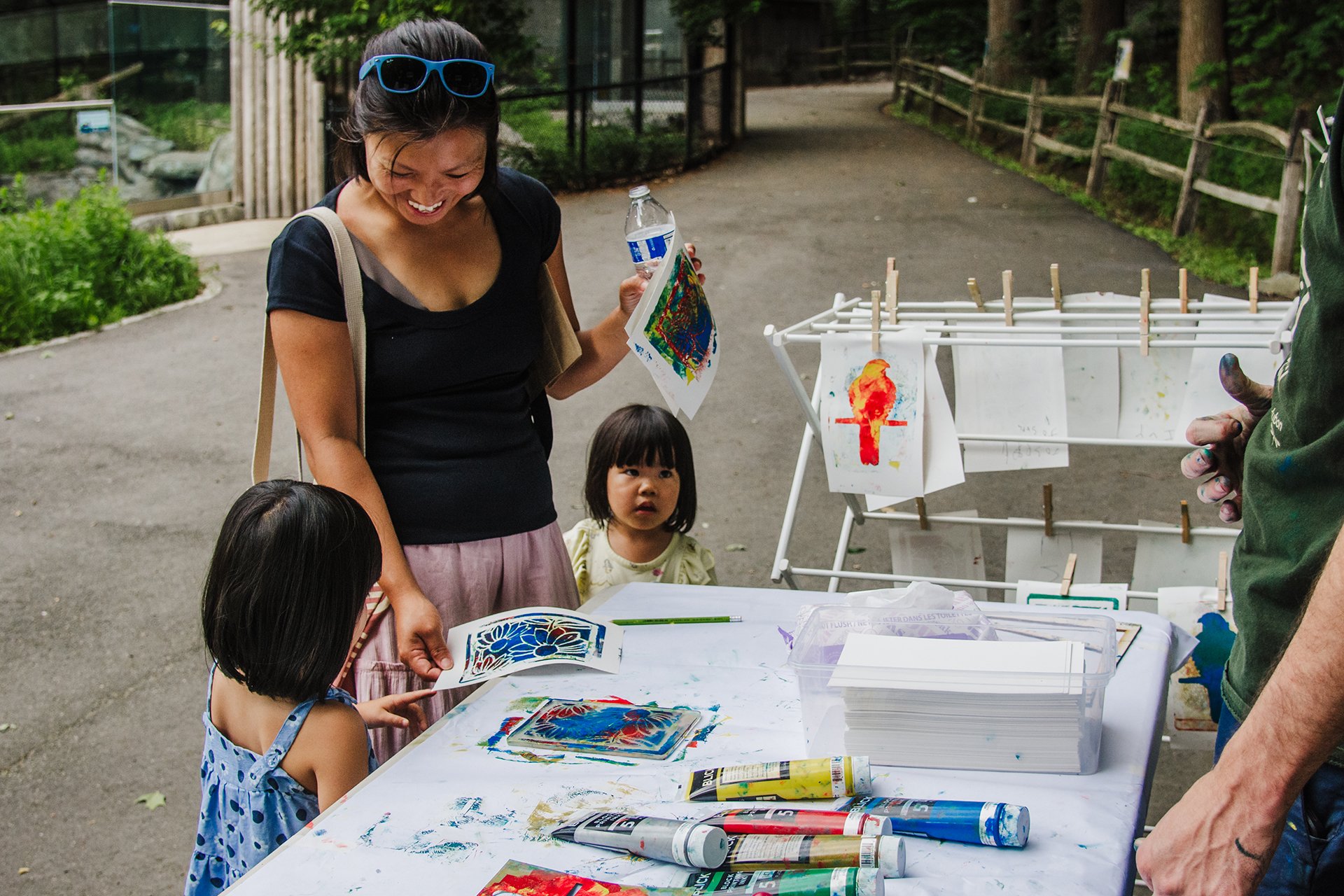 Children and their guardian at a pop-up arts and crafts table