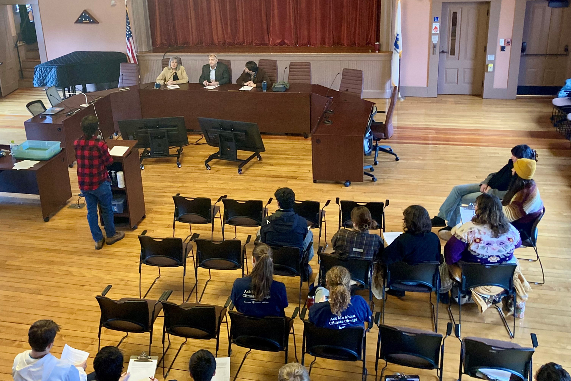 Youth Climate Action Summit attendee addressing the Sandwich Town Hall, seen from above the audience