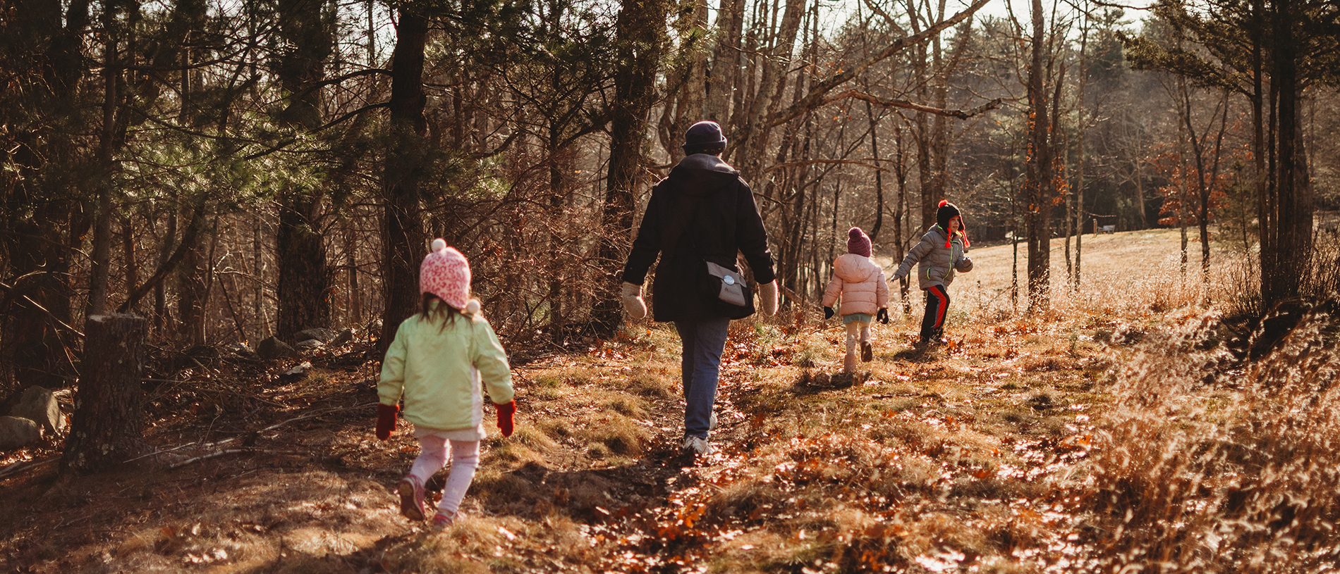Young kids walking on a trail in winter
