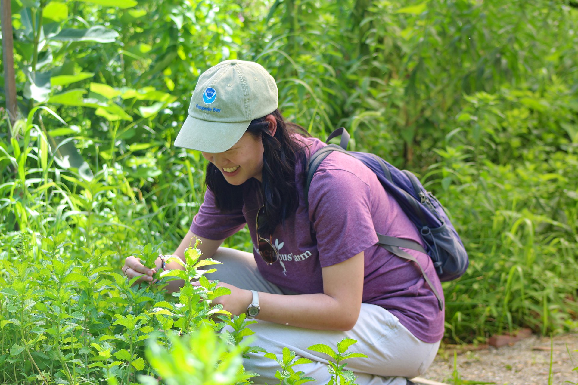 Young woman looking down at a leaf