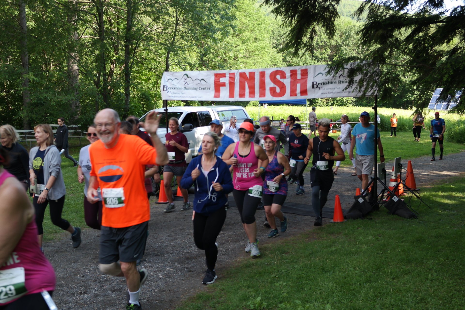 Racers running under finish banner at Pleasant Valley