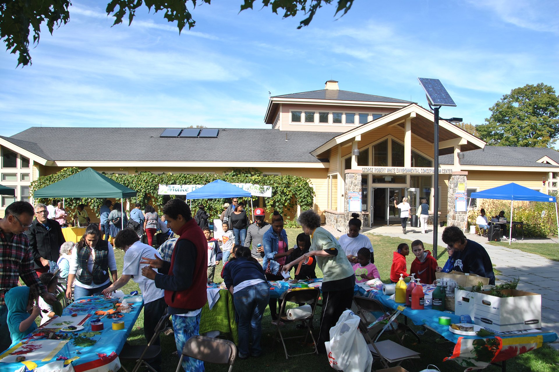 Rockin' with Raptors attendees at tables outside the nature center