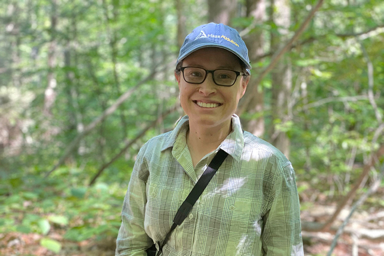 Portrait of Stephanie Kane outdoors wearing a Mass Audubon hat