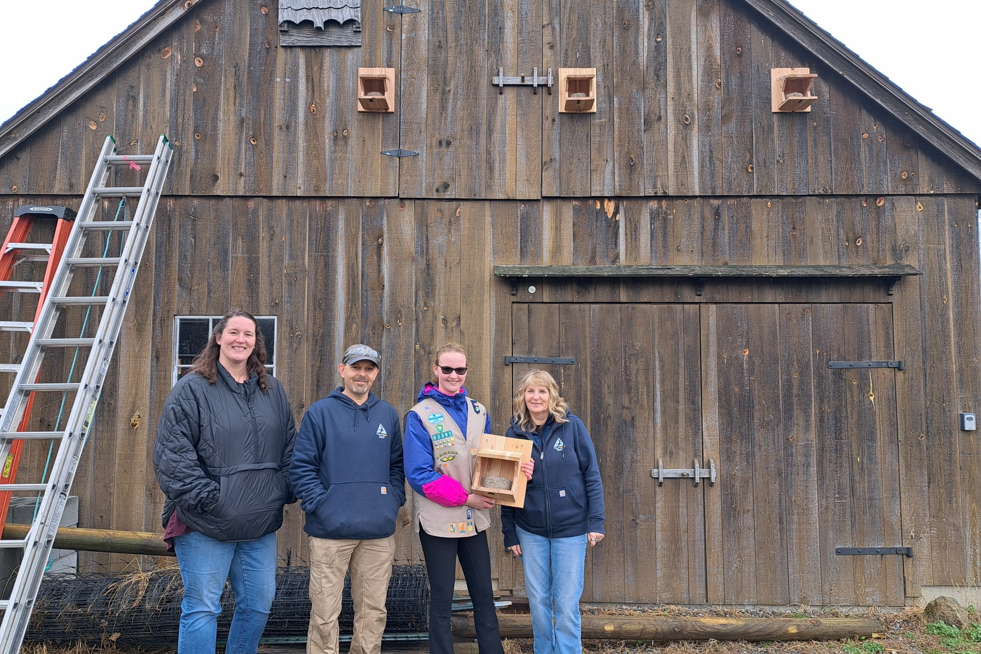 Staff and Beatrice standing in front of new nest boxes