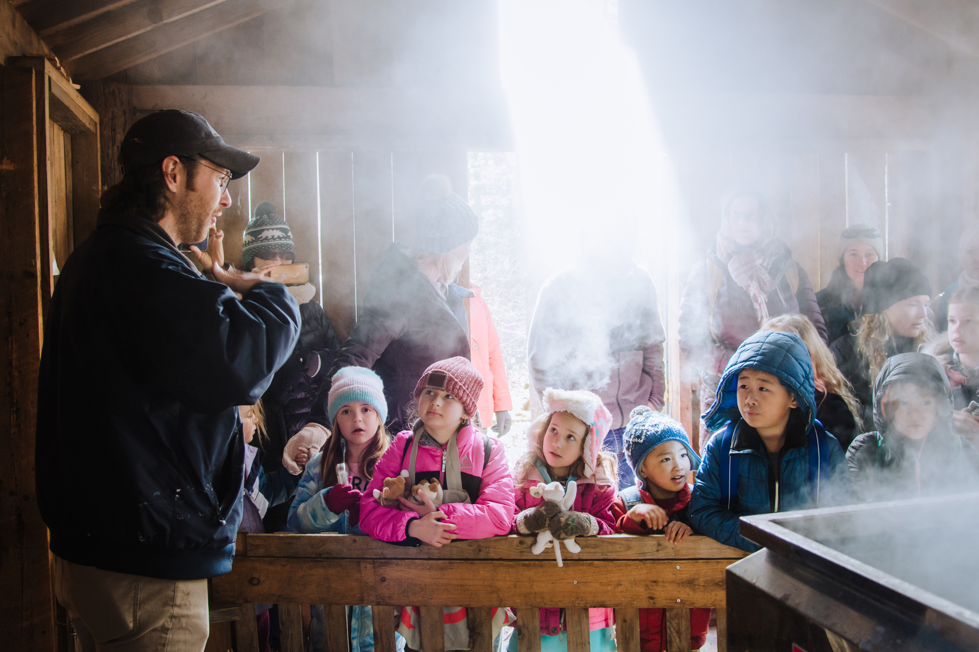 Children learning about the process of maple sugaring