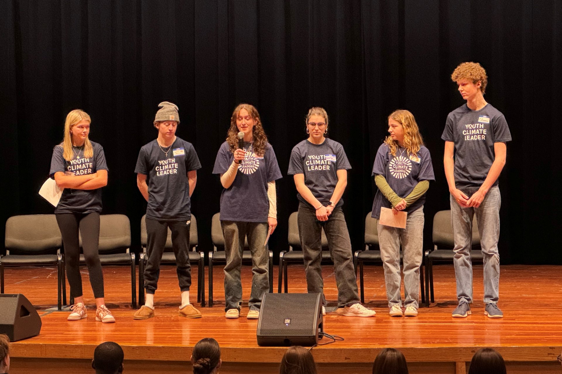 Members of the Youth Climate Leadership Program (YCLP) speak onstage.