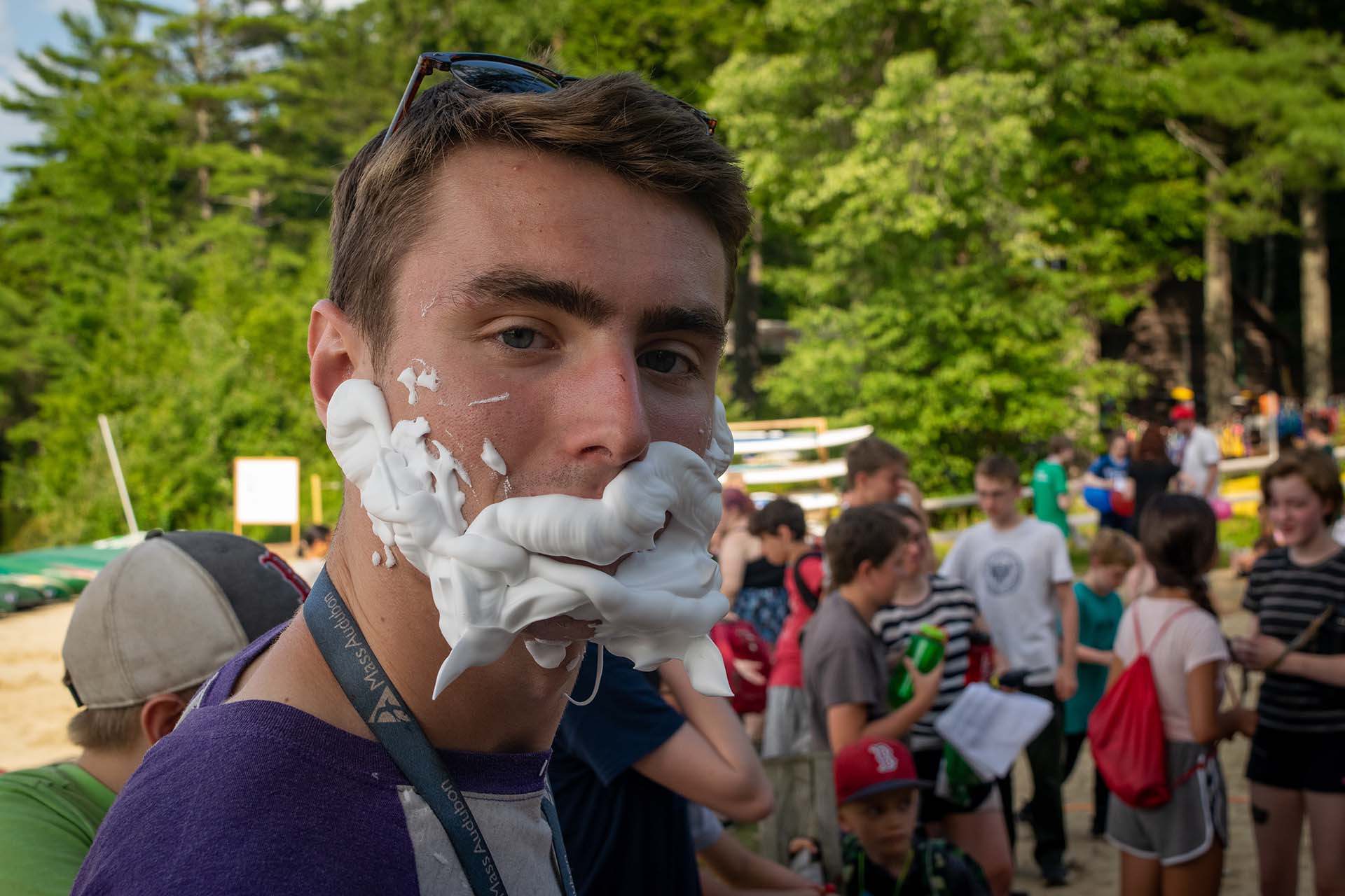 Person with shaving cream spread across their face.