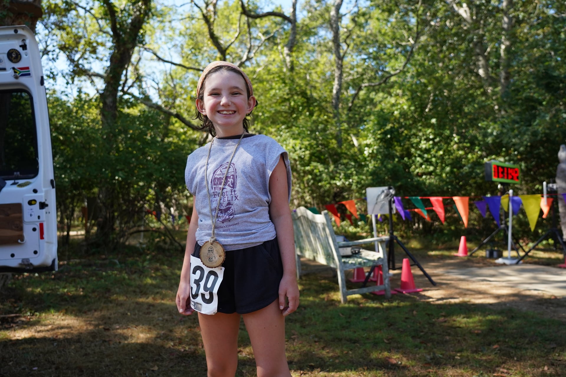 Young girl in running gear with a medal
