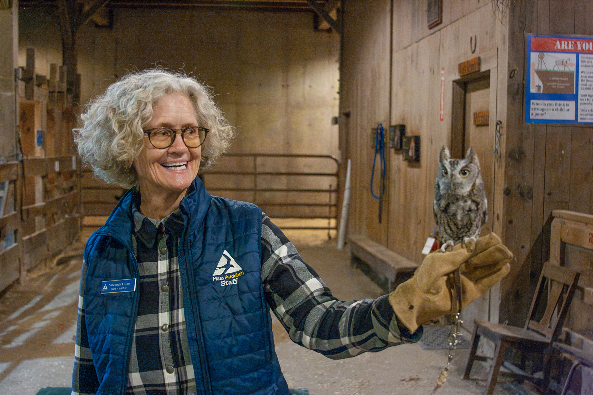 Wildlife Educator Susannah holding an owl, perched on her outstretched gloved hand