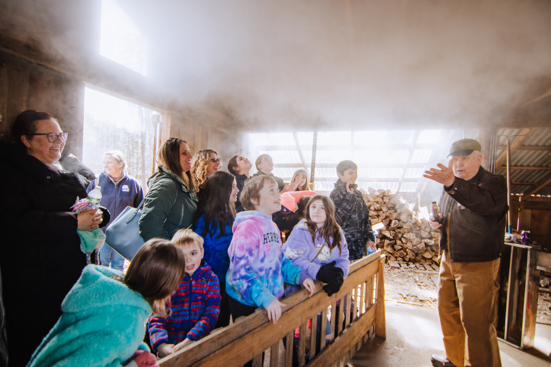 Moose Hill staff giving a maple sugaring demonstration for a small crowd