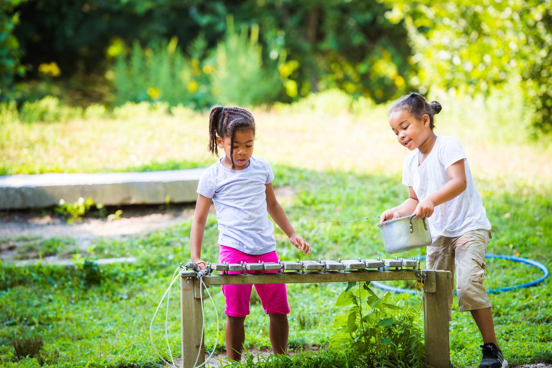 Two children playing with big xylophone