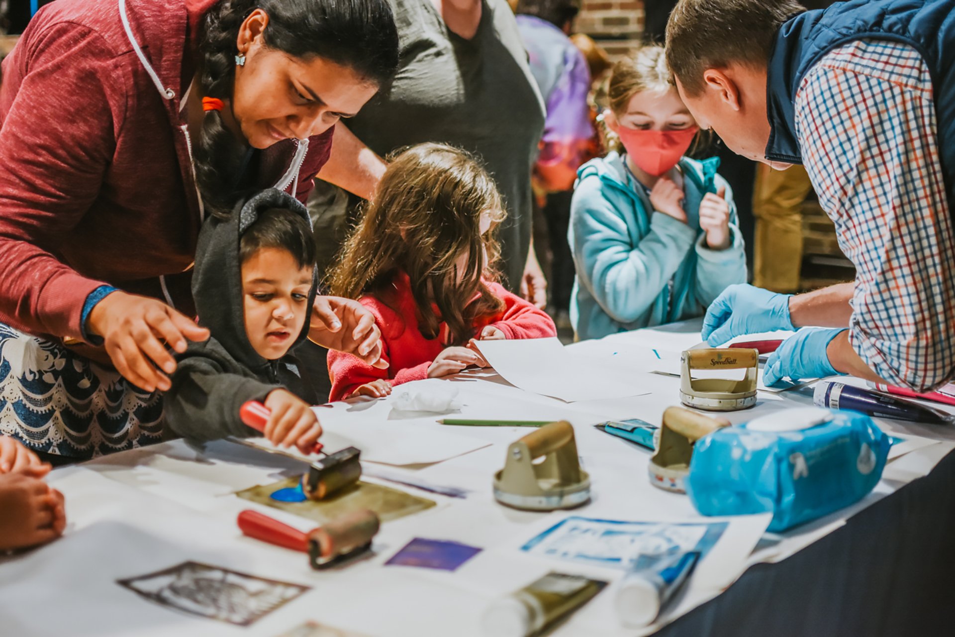 Families participating in a printmaking activity