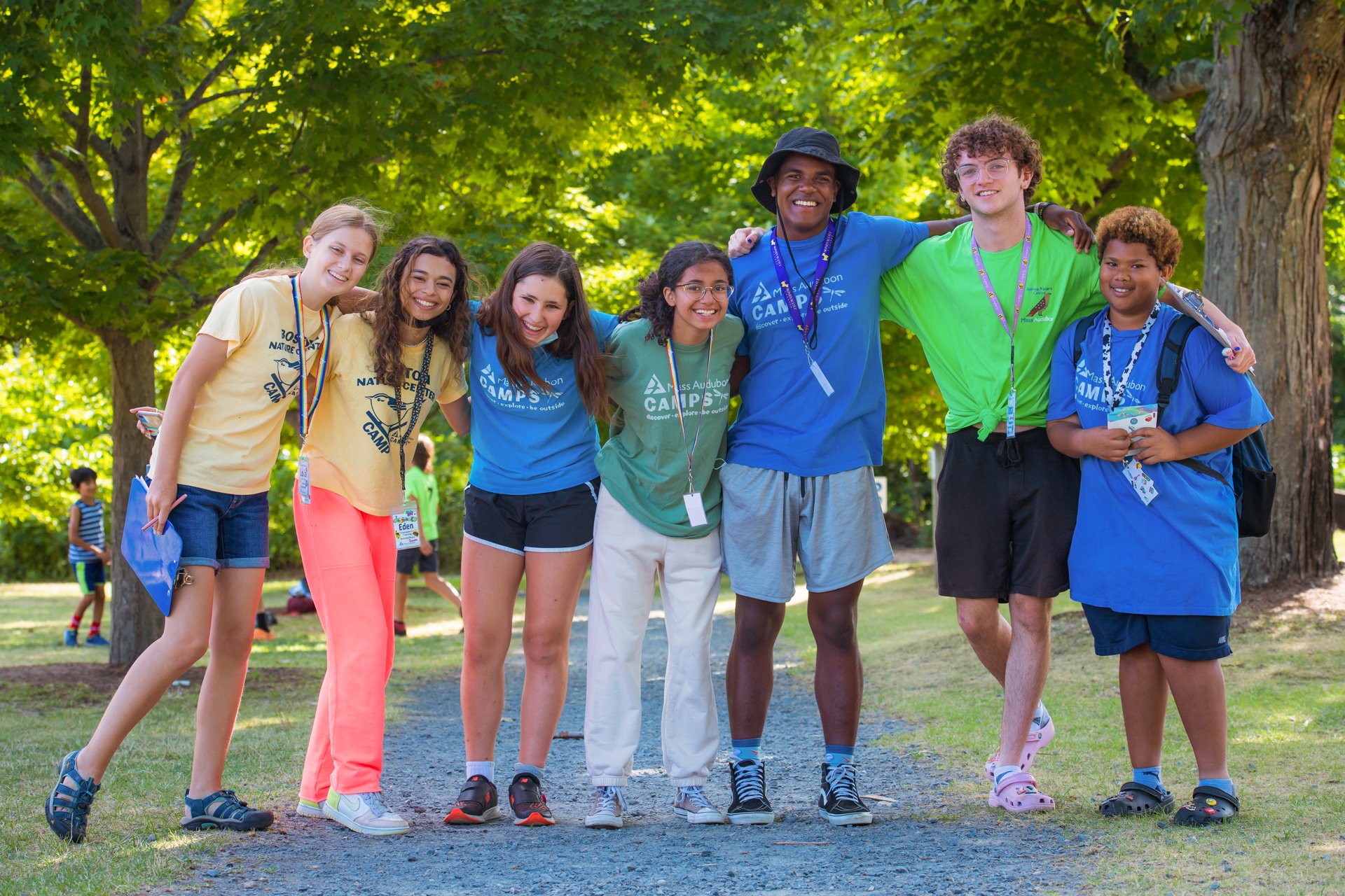 A group of counselors and CITs at Boston Nature Center Camp pose for a photo with arms around each other