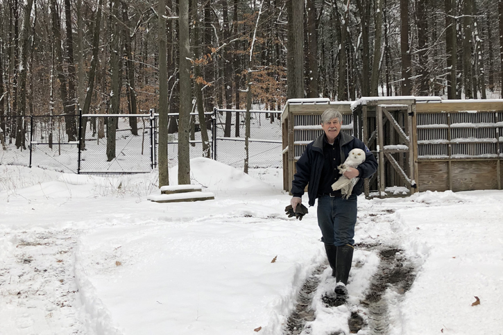 Norman Smith walking with a Snowy Owl at Trailside Museum