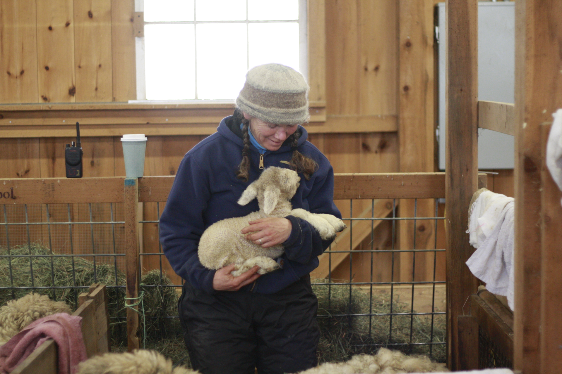 Farmer Caroline holding lamb lovingly