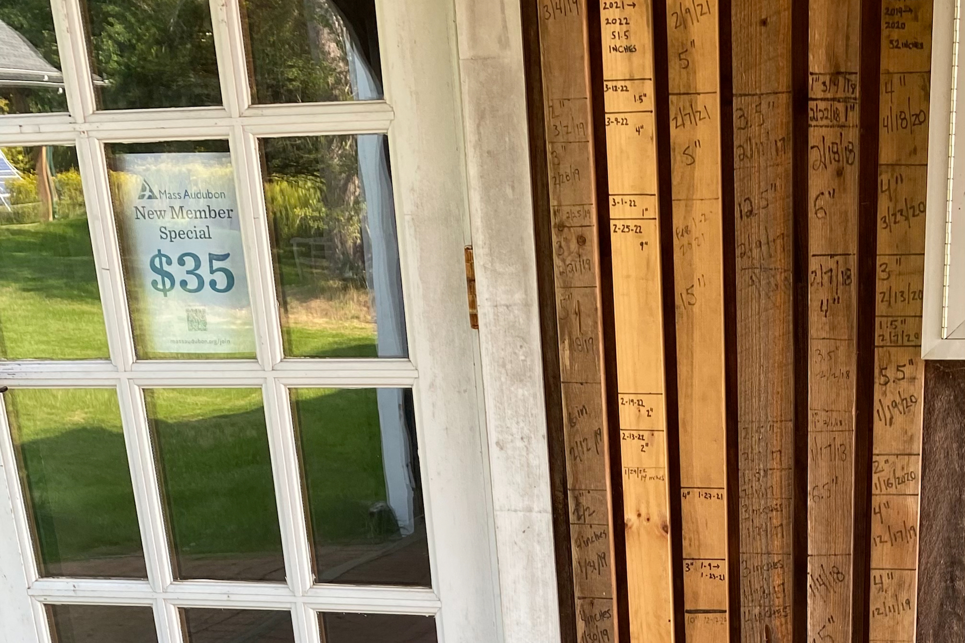 Marks on wood next to a door denoting annual snowfall