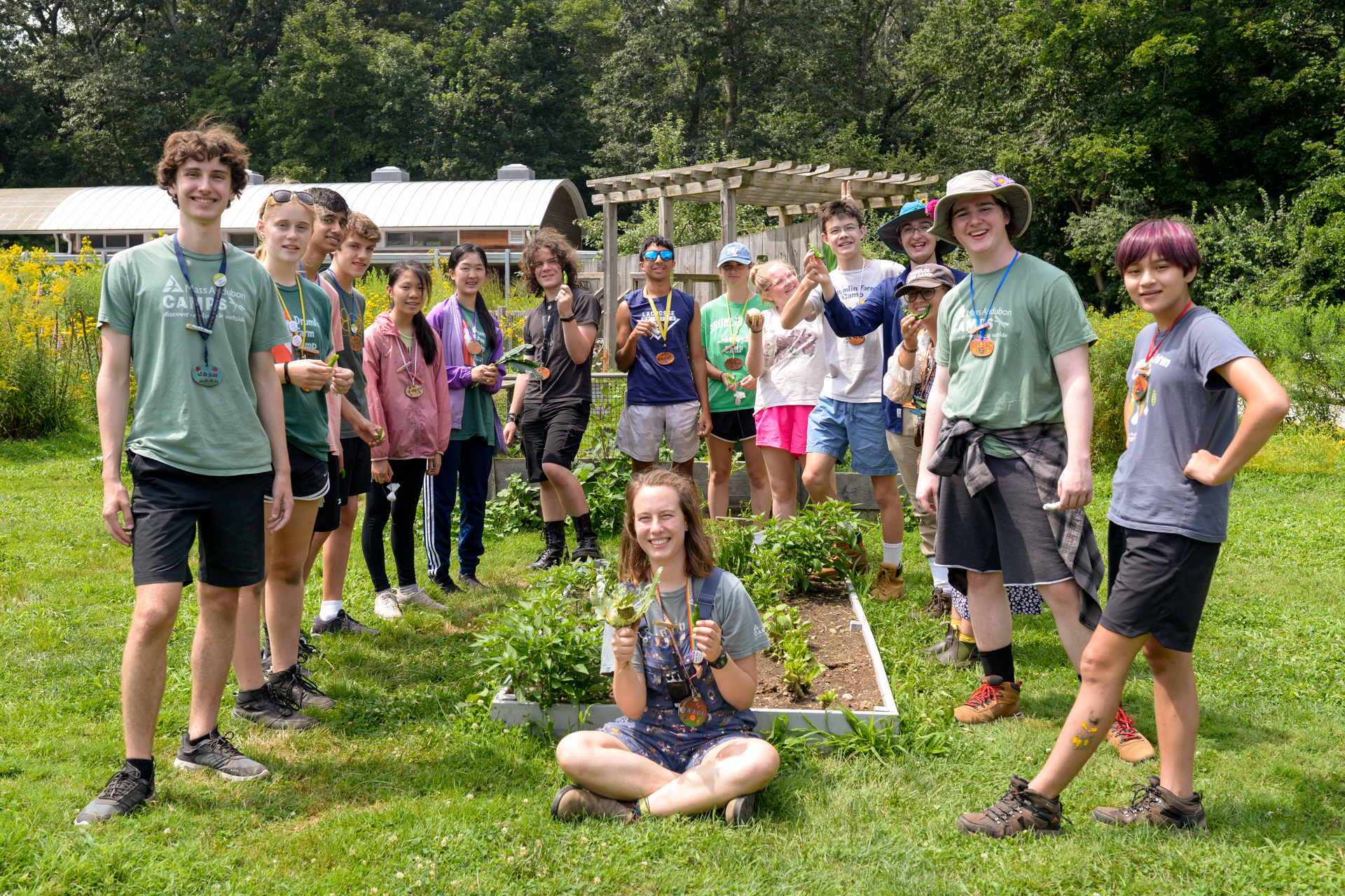 A group of Counselors-in-training (CITs) at Drumlin Farm Camp posing in the garden