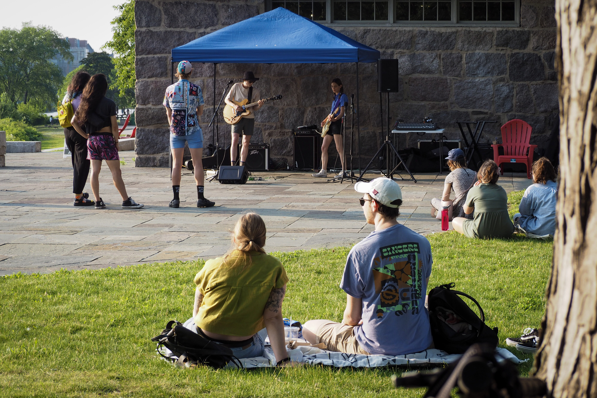 Two people on blanket watching live music