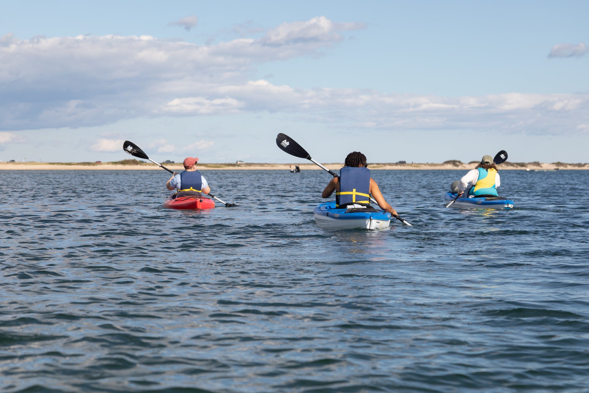 Three kayakers out on open water