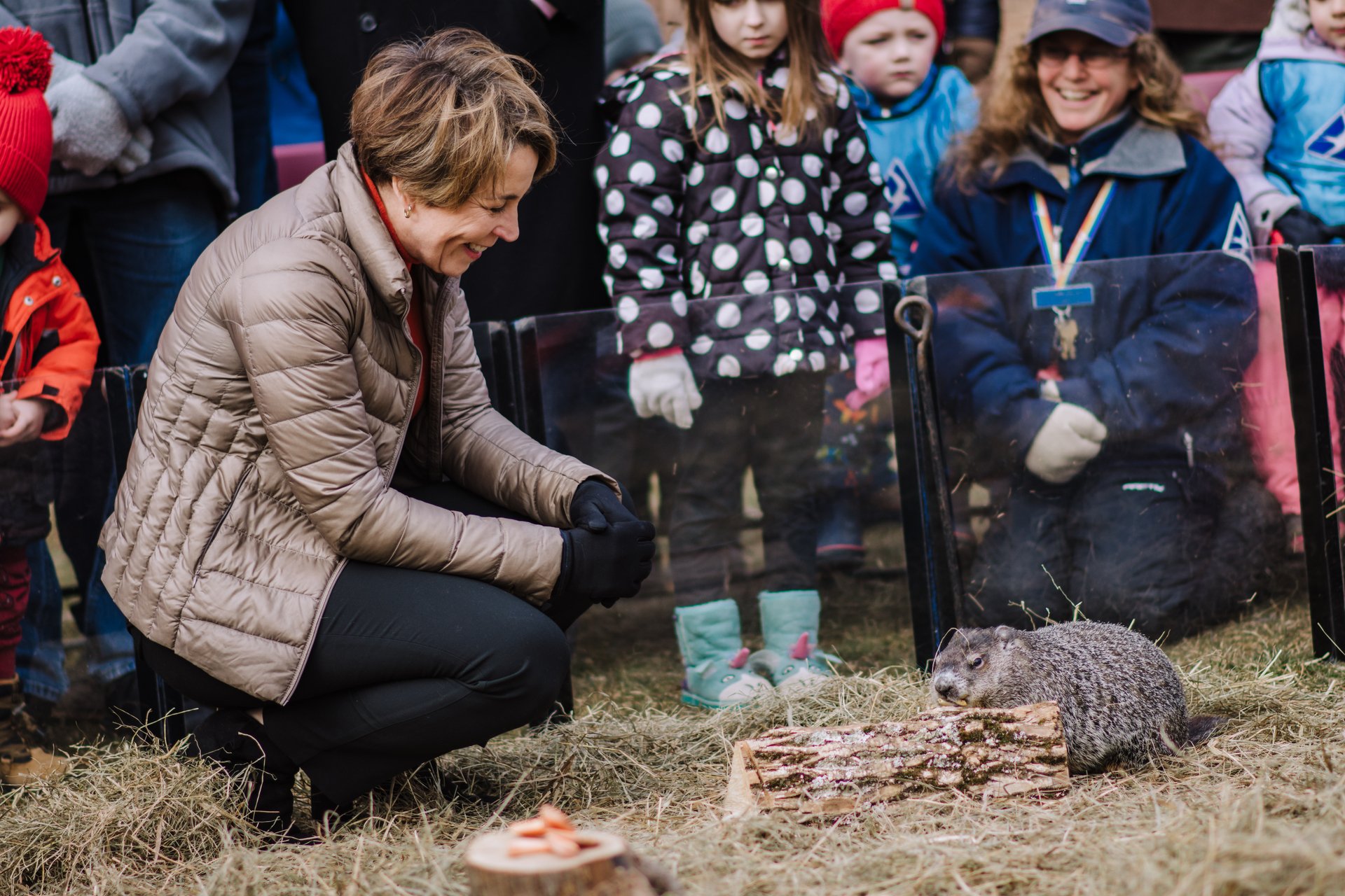 Woman crouching with woodchuck
