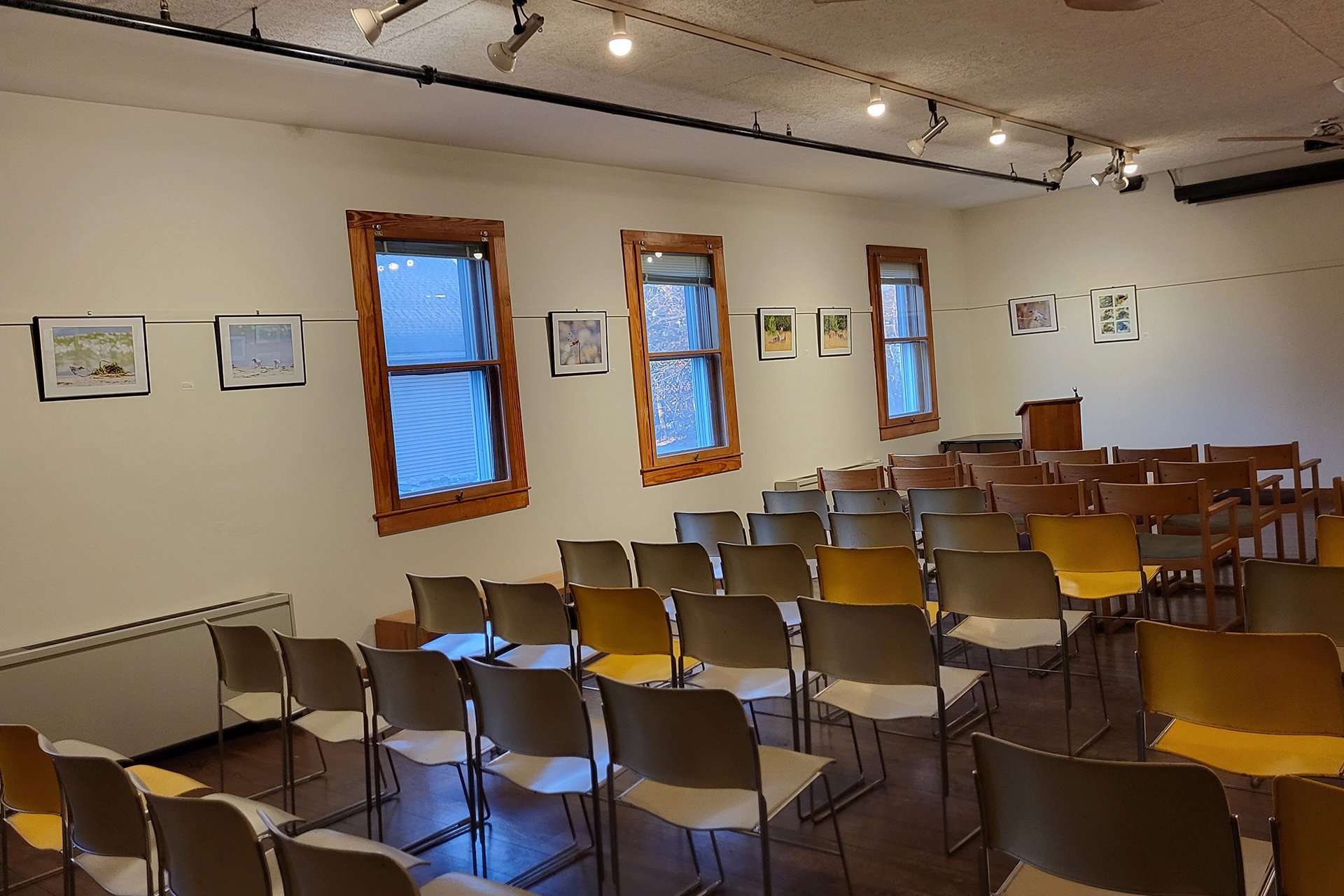 Framed photographs line the gallery wall at Broadmoor Wildlife Sanctuary.