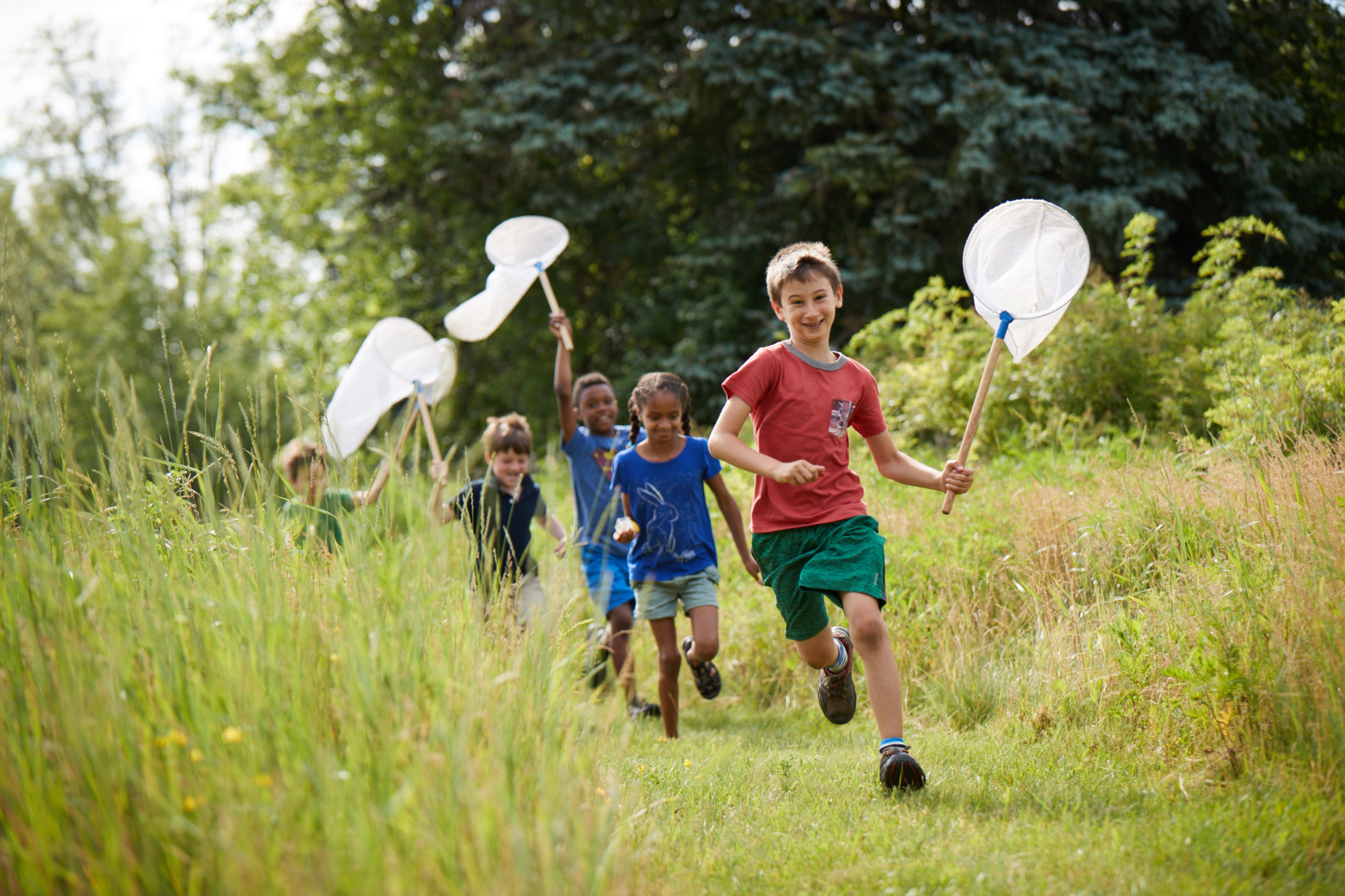 Campers Running Through Field with Nets