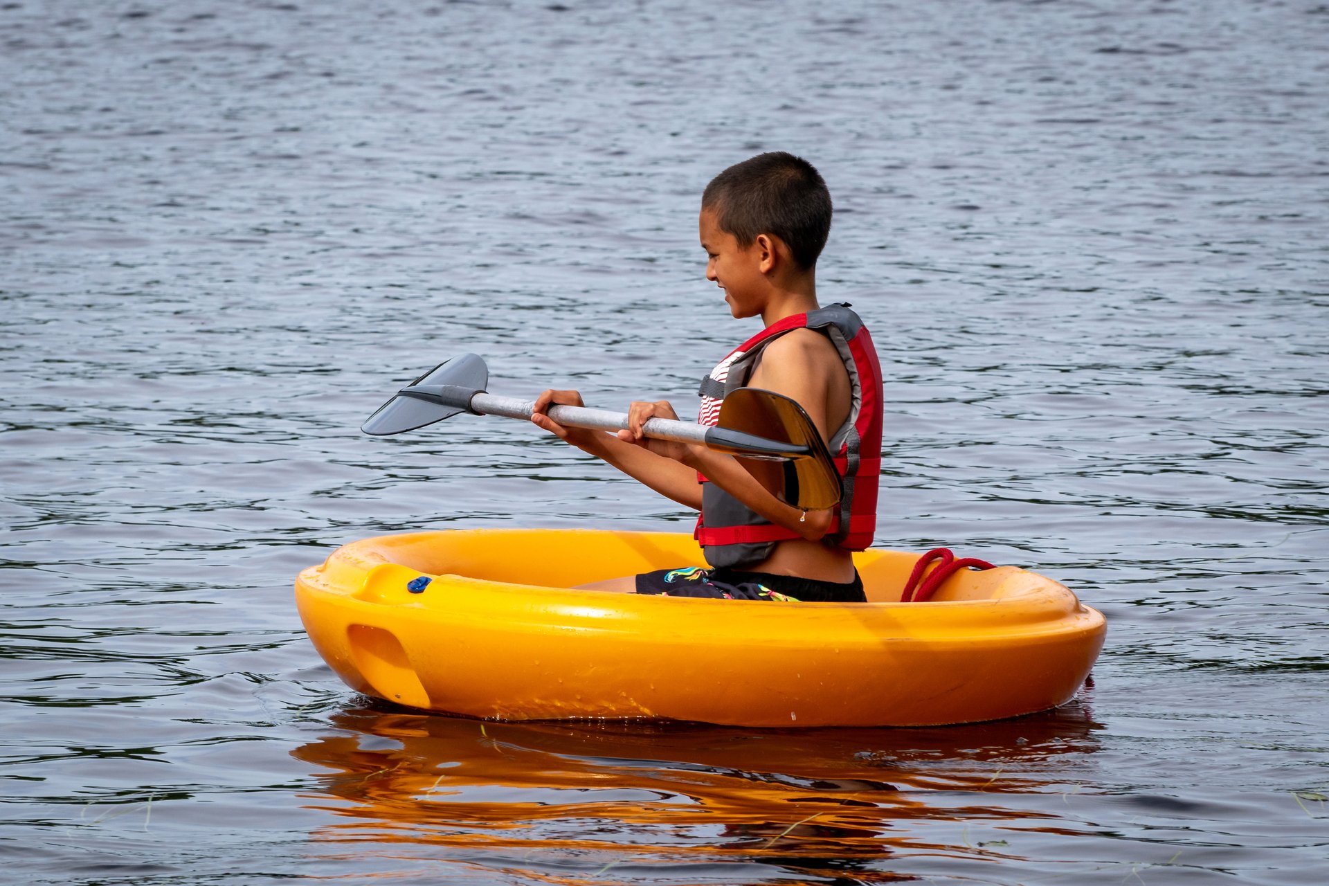 boy in little boat with a paddle