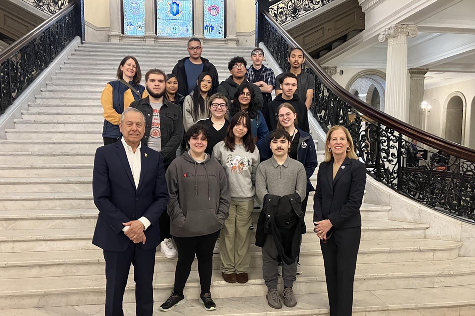 YCLP participants posing for a group photo on a grand staircase inside the Massachusetts State House