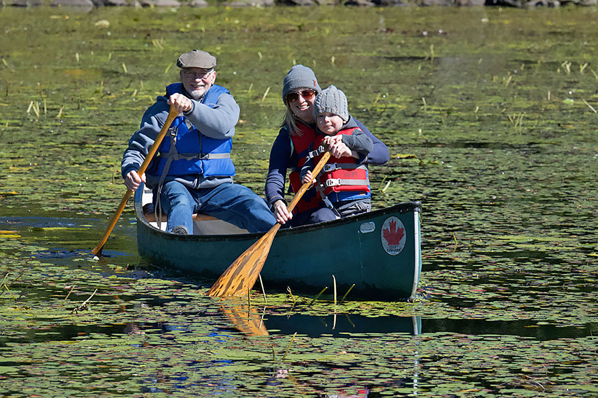 Family canoeing on the pond