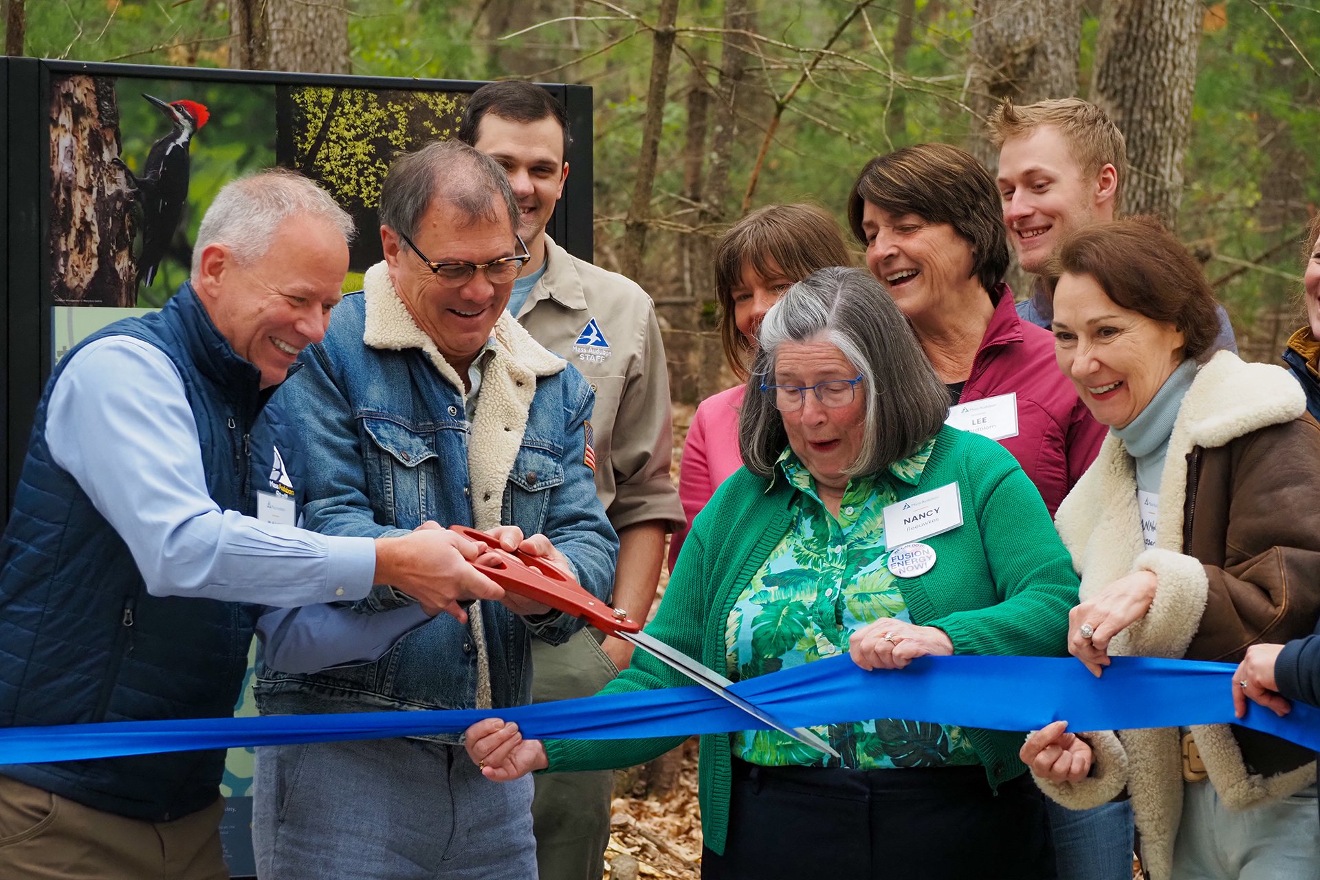 David O'Neill and guests cutting a blue ribbon at Brewster's Woods