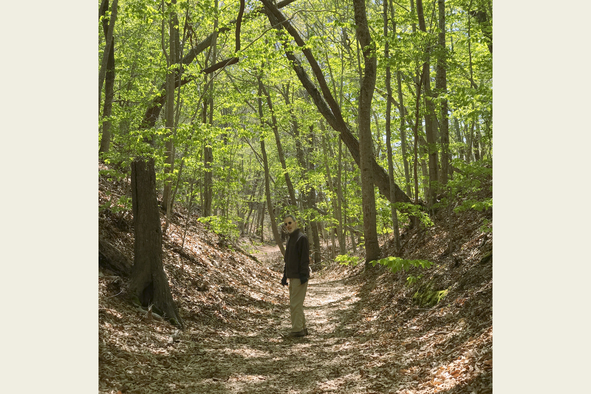 Photograph of a person standing on a trail