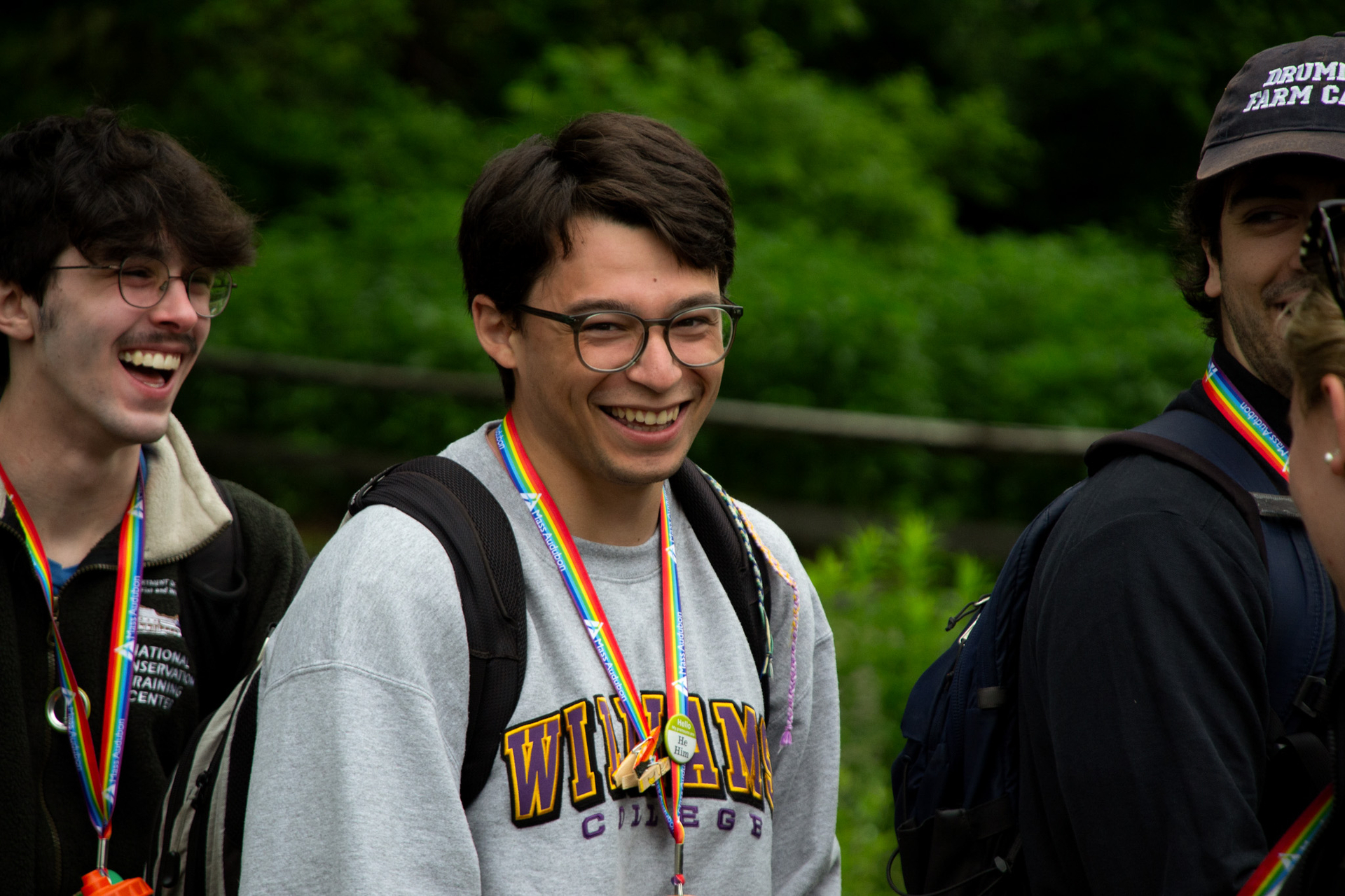 A counselor wearing glasses smiles at the camera.