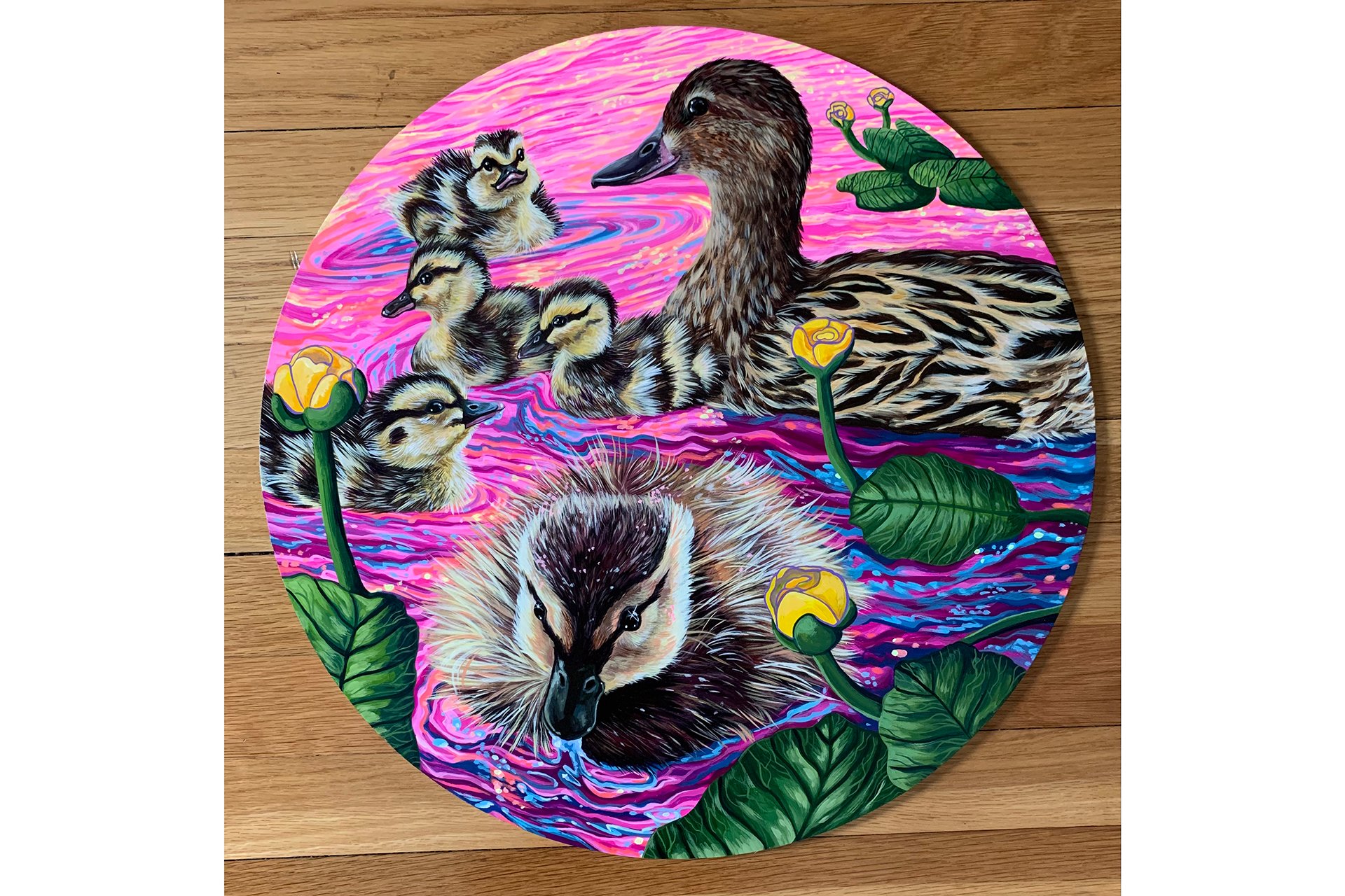 Pink-hued painting on round canvas of a duck and chicks