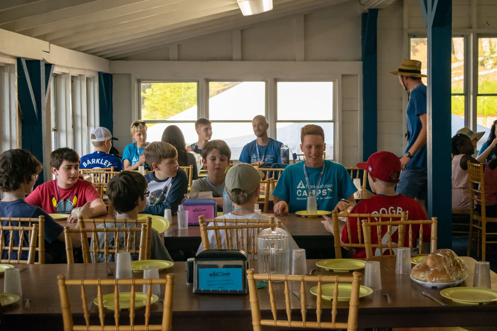 Campers in the dining hall at tables