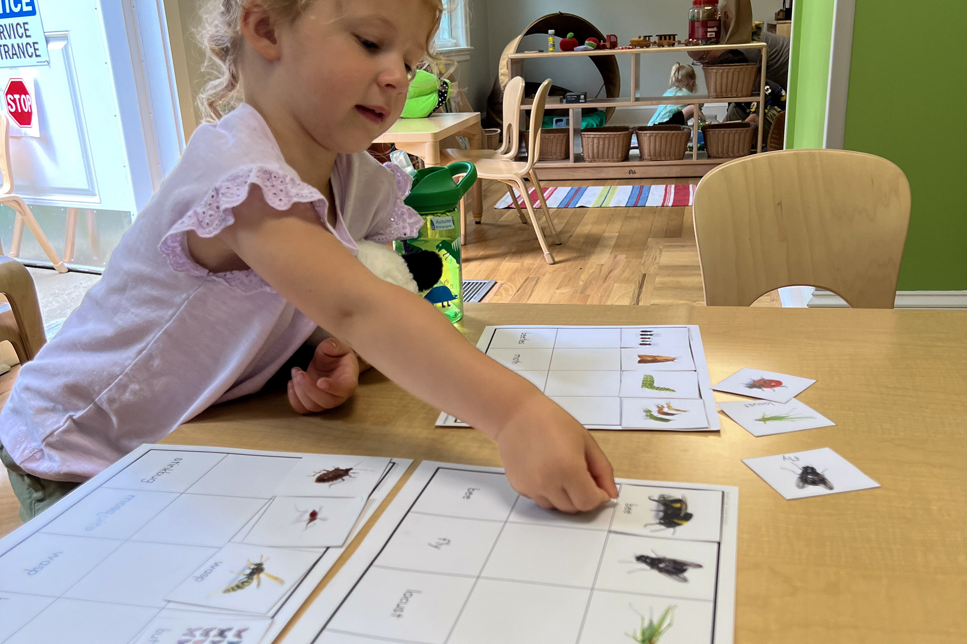 A preschooler doing a matching activity at a table