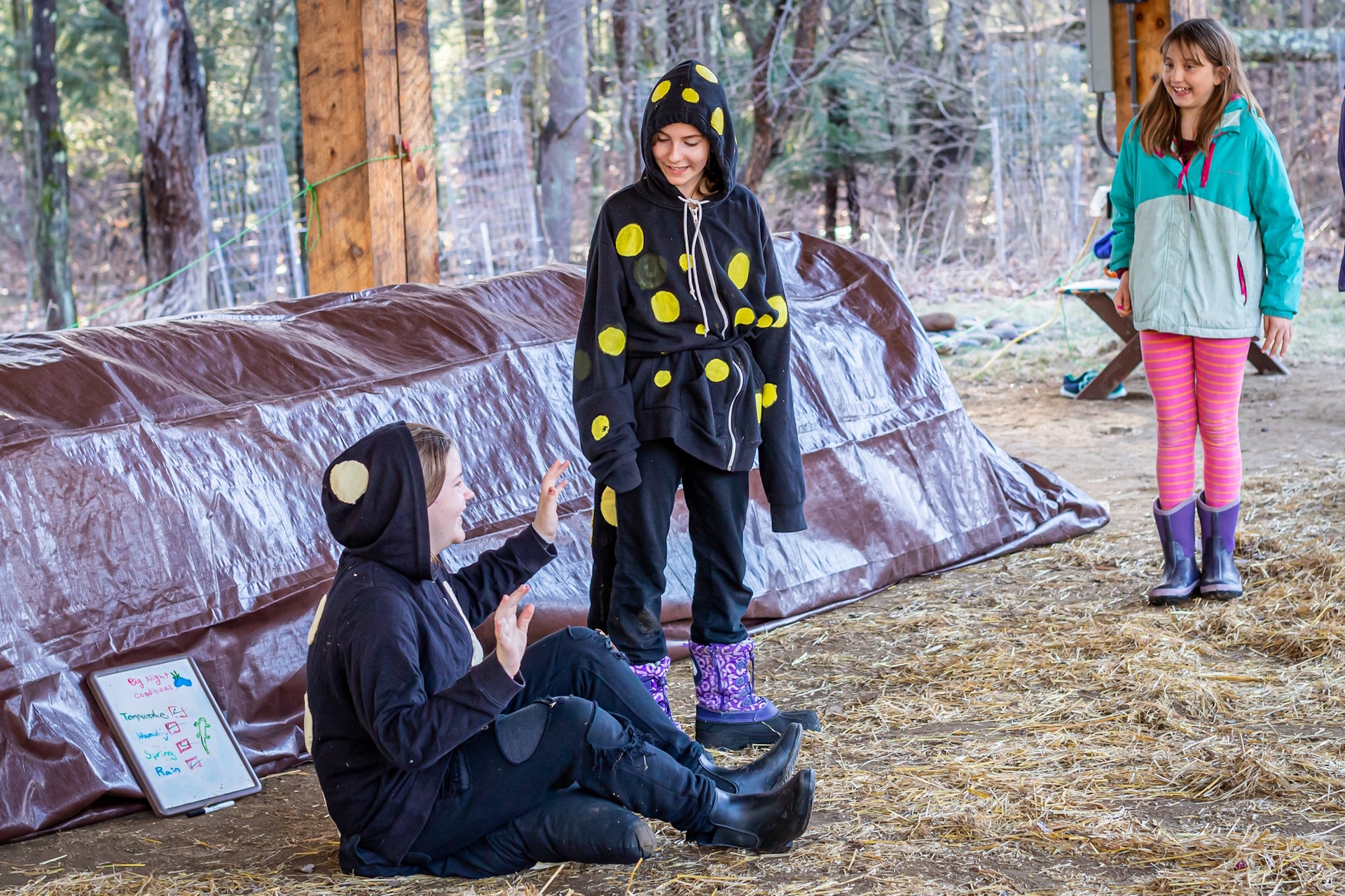 Three performers putting on a play outdoors